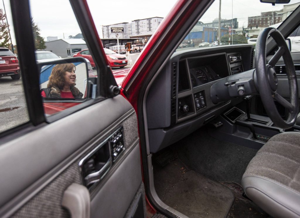 Barb Denton with her Jeep Cherokee Laredo that she calls the Red Dragon. (Olivia Vanni / The Herald)