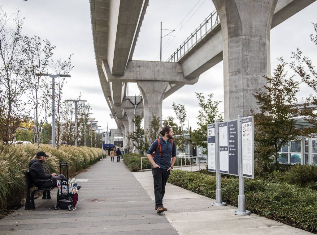 Jordan Hansen pauses to read the Link light rail map at Northgate Station on Wednesday, Oct. 4, 2023 in Seattle, Washington. (Olivia Vanni / The Herald)