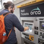 Jordan Hansen buys his light rail ticket at Northgate Station on Wednesday, Oct. 4, 2023 in Seattle, Washington. (Olivia Vanni / The Herald)