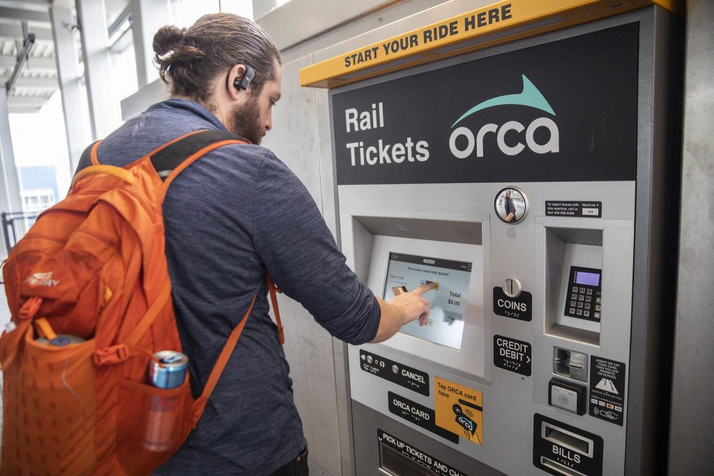 Jordan Hansen buys his light rail ticket at Northgate Station on Wednesday, Oct. 4, 2023 in Seattle, Washington. (Olivia Vanni / The Herald)