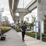 Jordan Hansen pauses to read the Link light rail map at Northgate Station on Wednesday, Oct. 4, 2023, in Seattle, Washington. (Olivia Vanni / The Herald)