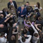 Speaker of the House Kevin McCarthy, R-Calif., is surrounded by reporters looking for updates on plans to fund the government and avert a shutdown, at the Capitol in Washington, Friday, Sept. 22, 2023. (AP Photo/J. Scott Applewhite)