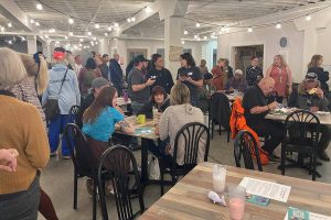 People talk and enjoy food Friday evening at the Snohomish County Recovery Coalition launch party in Everett, Washington. (Sophia Gates / The Herald)