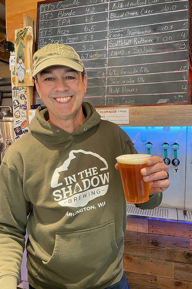Cole Rinehardt holds up a pint of ITS Double Fresh, a special collaboration fresh-hop beer made by In The Shadow Brewing and Double Arrow Brewing. (Photo provided)
