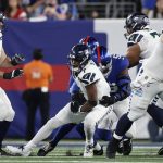 Seattle Seahawks quarterback Geno Smith (7) is sacked by New York Giants linebacker Azeez Ojulari (51) during the first quarter of an NFL football game, Monday, Oct. 2, 2023, in East Rutherford, N.J. (AP Photo/Adam Hunger)