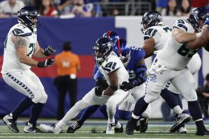 Seattle Seahawks quarterback Geno Smith (7) is sacked by New York Giants linebacker Azeez Ojulari (51) during the first quarter of an NFL football game, Monday, Oct. 2, 2023, in East Rutherford, N.J. (AP Photo/Adam Hunger)
