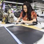 My Luu Dau works on stitching a product at Kaas Tailored on Tuesday, Oct. 10, 2023 in Mukilteo, Washington. (Olivia Vanni / The Herald)