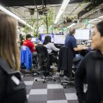 Kaas Tailored employees work while people tour their facility on Tuesday, Oct. 10, 2023 in Mukilteo, Washington. (Olivia Vanni / The Herald)
