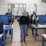 People walk through Pathfinder Manufacturing during the Association of Washington Business annual Manufacturing Week tour on Tuesday, Oct. 10, 2023 in Everett, Washington. (Olivia Vanni / The Herald)