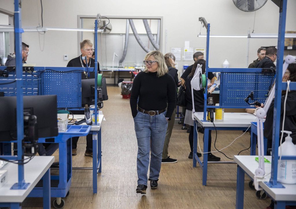 People walk through Pathfinder Manufacturing during the Association of Washington Business annual Manufacturing Week tour on Tuesday, Oct. 10, 2023 in Everett, Washington. (Olivia Vanni / The Herald)