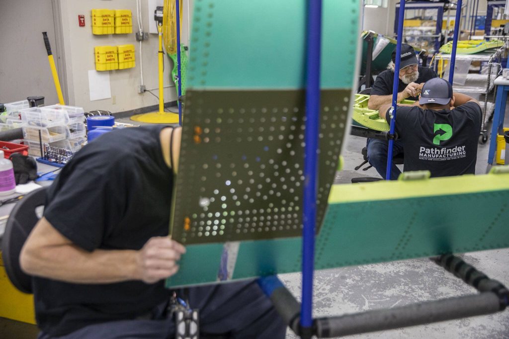 Pathfinder employees work on different airplane parts at Pathfinder Manufacturing on Tuesday, Oct. 10, 2023 in Everett, Washington. (Olivia Vanni / The Herald)