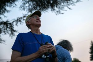 Jeff Hambleton from the Pilchuck Audubon Society watches the sky during Swifts Night Out on Saturday, August 19, 2023, at the Wagner Performing Arts Center in Monroe, Washington. (Ryan Berry / The Herald)