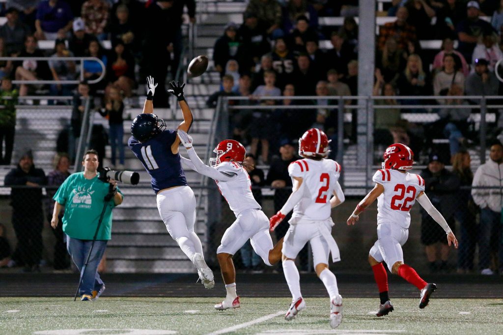 Arlingtons Jeremy Fleming comes down with the ball, but barely out of bounds, against Marysville Pilchuck on Friday, Oct. 6, 2023, at Arlington High School in Arlington, Washington. (Ryan Berry / The Herald)