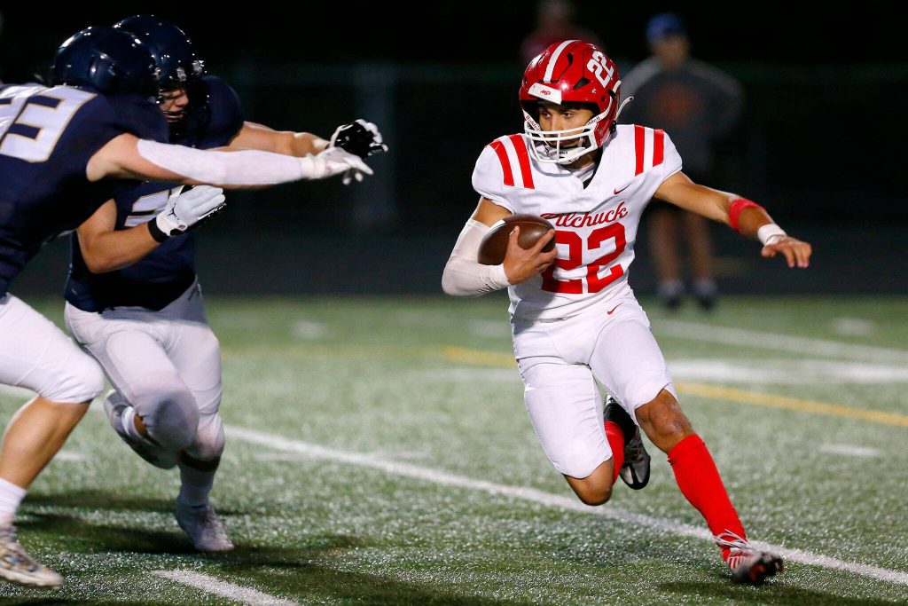 Marysville Pilchuck junior running back Joseph Davis takes a handoff for a big gain against Arlington on Friday, Oct. 6, 2023, at Arlington High School in Arlington, Washington. (Ryan Berry / The Herald)