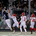 Arlington’s Jeremy Fleming comes down with the ball, but barely out of bounds, against Marysville Pilchuck on Friday, Oct. 6, 2023, at Arlington High School in Arlington, Washington. (Ryan Berry / The Herald)