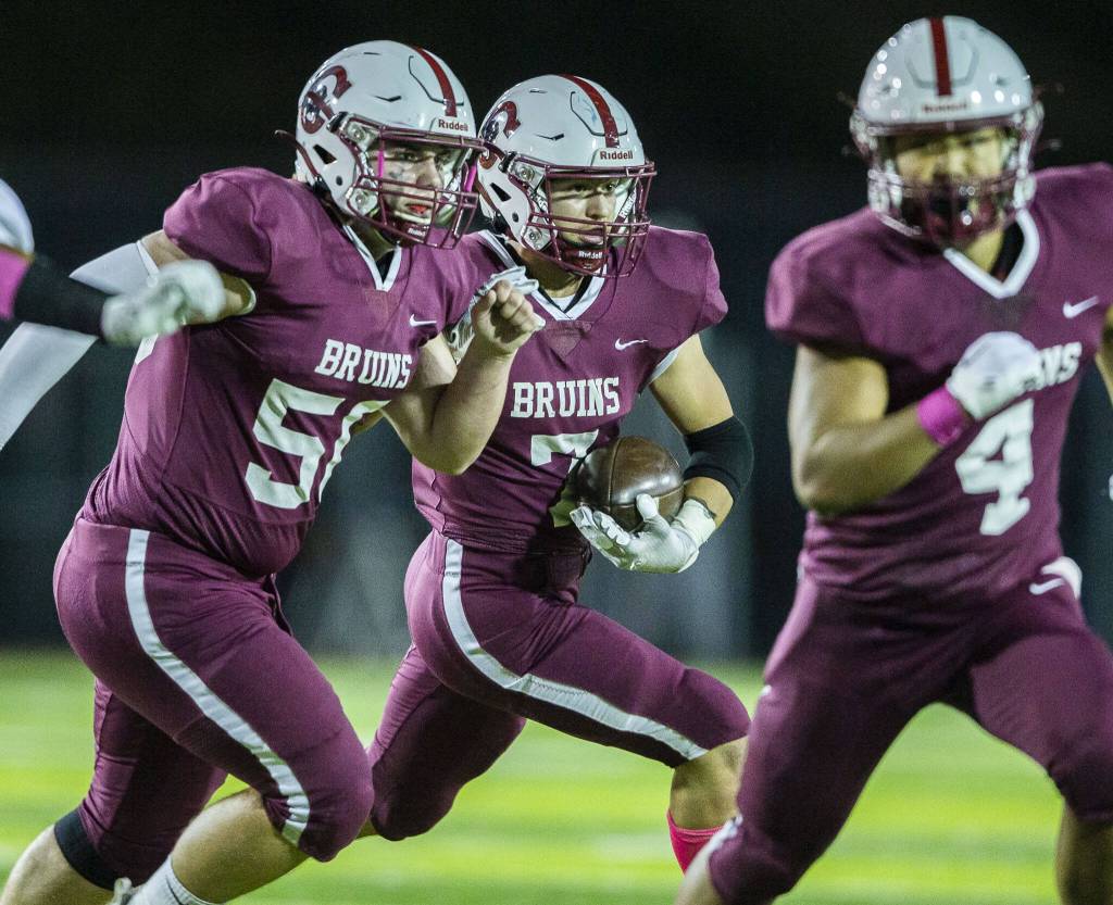 Cascades Zach Lopez looks for an opening while running the ball during the game against Everett on Friday, Oct. 6, 2023 in Everett, Washington. (Olivia Vanni / The Herald)