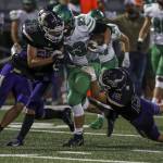 Lake Stevens David Brown (33) and Jesse Lewis (15) go in for a tackle on West Linns Ryan Vandenbrink during a game Sept. 22 at Lake Stevens High School. (Annie Barker / The Herald)
