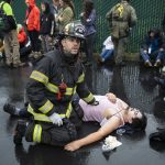 Snohomish firefighter Joshua Poole talks with another firefighter while administering aid to a victim during a mass casualty training on Wednesday, Oct. 11, 2023 in Snohomish, Washington. (Olivia Vanni / The Herald)