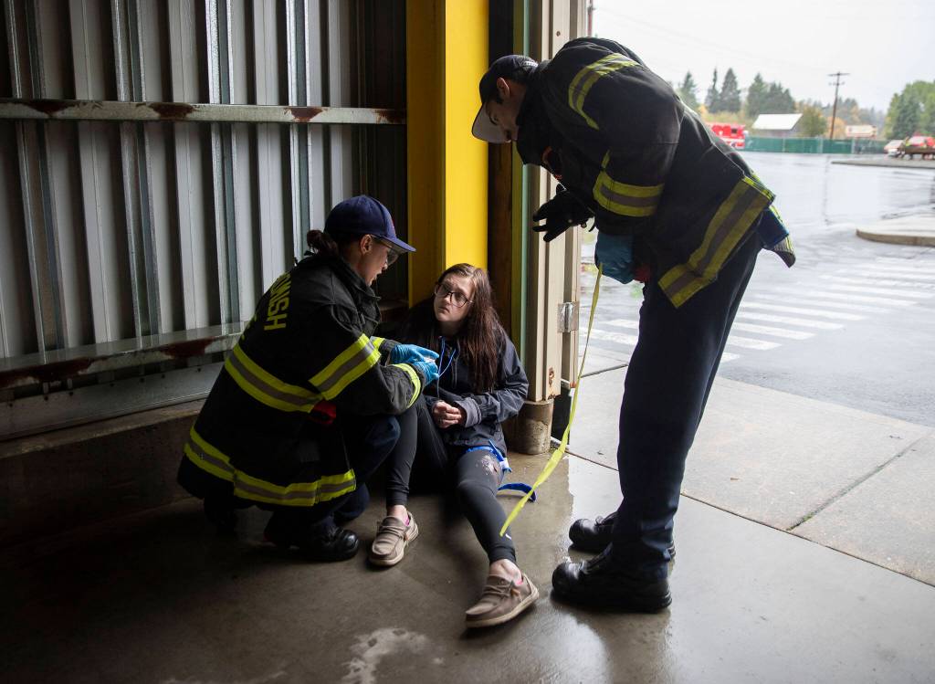 Snohomish firefighters tend to a wounded victim during a mass casualty training on Wednesday, Oct. 11, 2023 in Snohomish, Washington. (Olivia Vanni / The Herald)