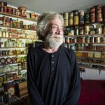 Daniel Weiss, 73, inside his tin room at his Mountlake Terrace home that holds the majority of his collection of about 1,400 vintage tins that he is selling. (Olivia Vanni / The Herald)