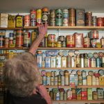 Daniel Weiss plus down a vintage tin that has remained unopened and still has brand new tennis balls inside. (Olivia Vanni / The Herald)