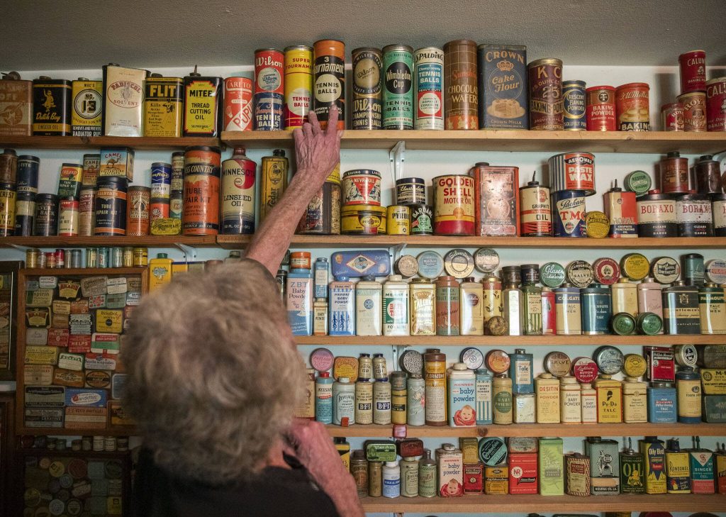 Daniel Weiss plus down a vintage tin that has remained unopened and still has brand new tennis balls inside. (Olivia Vanni / The Herald)
