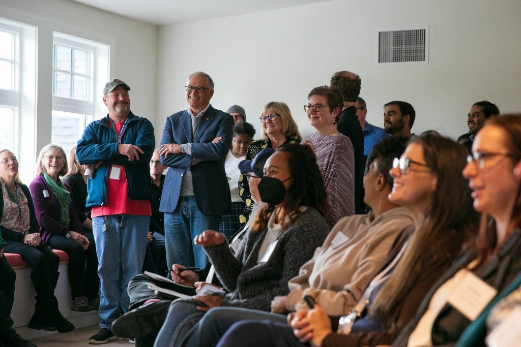 Gov. Jay Inslee waits in the wings as people speak during a ceremony celebrating the Evergreen Manor Family Services Center on Tuesday, Oct. 10, 2023, in Everett, Washington. (Ryan Berry / The Herald)