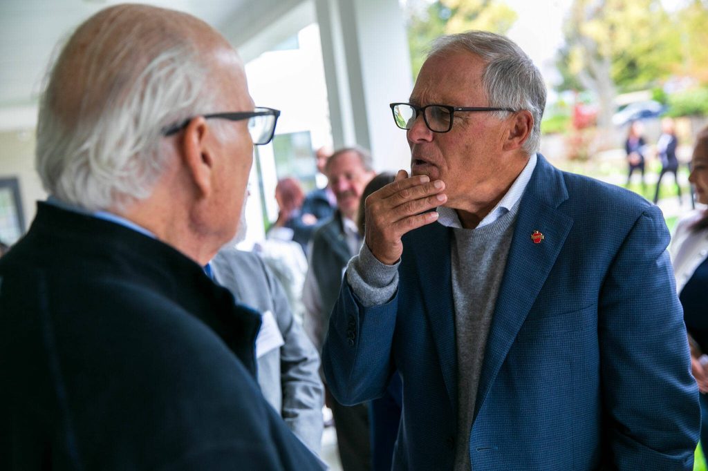 Gov. Jay Inslee chats with attendees during a ribbon cutting ceremony at the Evergreen Manor Family Services Center on Tuesday, Oct. 10, 2023, in Everett, Washington. (Ryan Berry / The Herald)