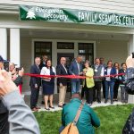 Gov. Jay Inslee and Evergreen Recovery Centers CEO Linda Grant cut the ceremonial ribbon during an event celebrating the Evergreen Manor Family Services Center on Tuesday, Oct. 10, 2023, in Everett, Washington. (Ryan Berry / The Herald)