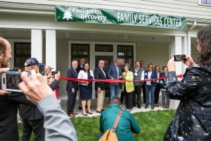 Gov. Jay Inslee and Evergreen Recovery Centers CEO Linda Grant cut the ceremonial ribbon during an event celebrating the Evergreen Manor Family Services Center on Tuesday, Oct. 10, 2023, in Everett, Washington. (Ryan Berry / The Herald)