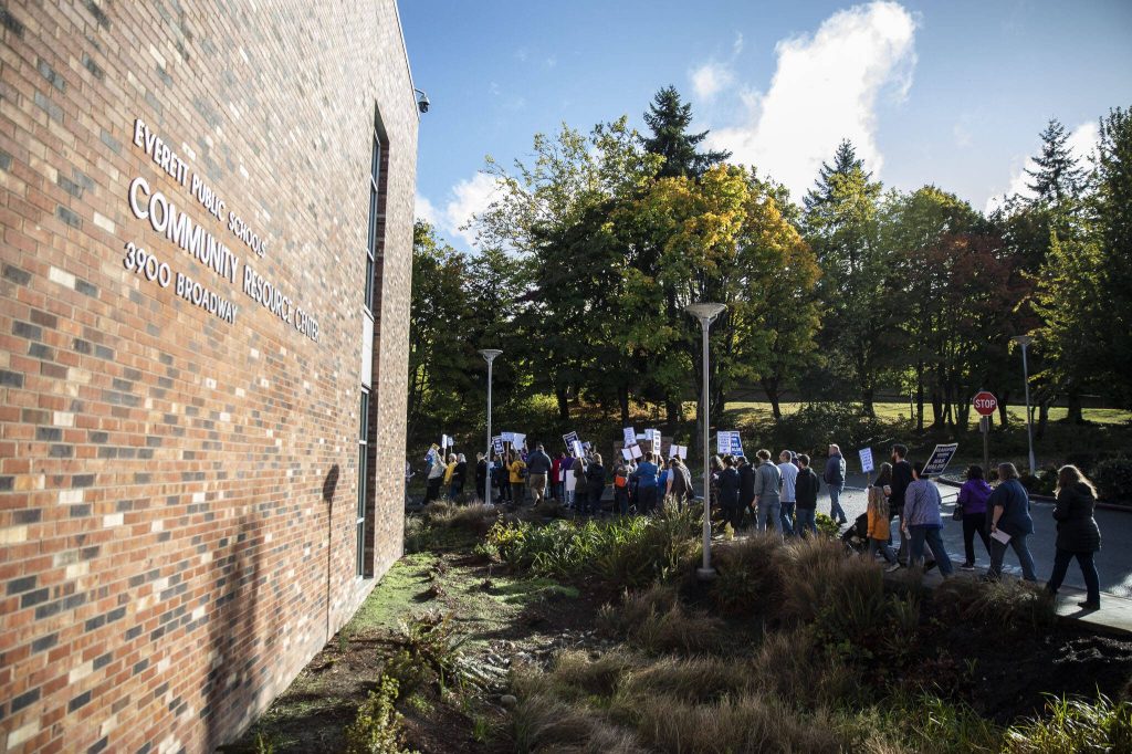 Protesters make their way down the sidewalk on 40th Street on Tuesday, Oct. 10, 2023 in Everett, Washington. (Olivia Vanni / The Herald)