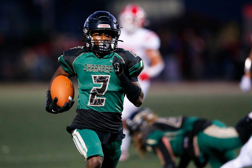 Marysville Getchells Shawn Etheridge takes a runs with the ball against Marysville Pilchuck during the Berry Bowl on Sept. 15 at Quil Ceda Stadium in Marysville. (Ryan Berry / The Herald)