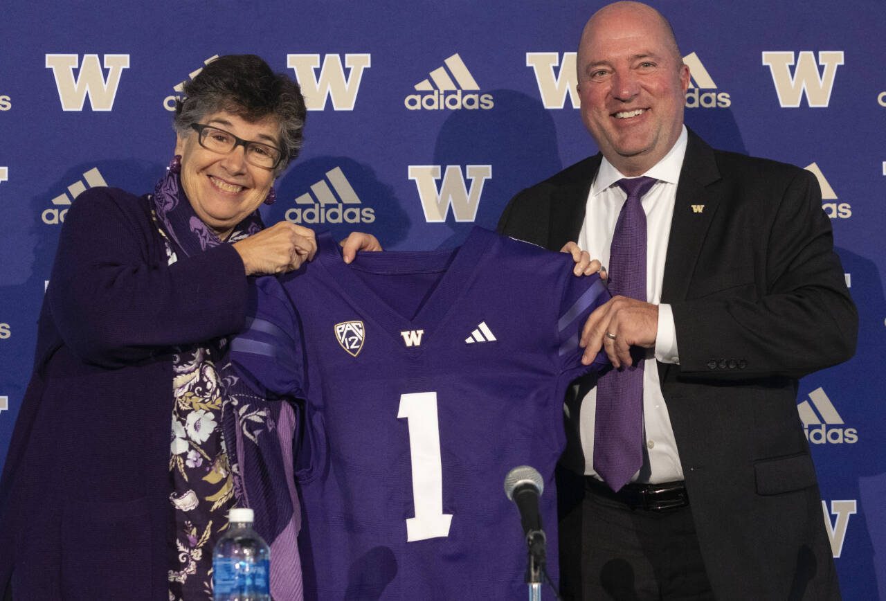 University of Washington President Ana Mari Cauce (left) introduces new UW Athletic Director Troy Dannen during a news conference Tuesday in Seattle. (Ken Lambert/The Seattle Times via AP)