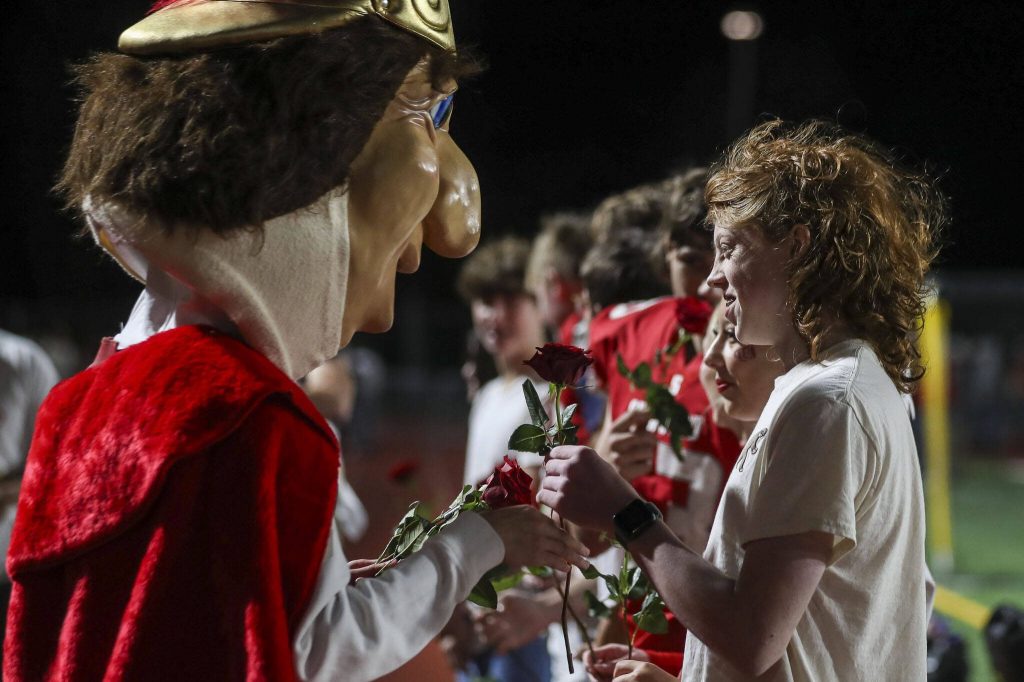 Members of the Stanwood homecoming court are given roses during a game between Marysville-Getchell and Stanwood at Stanwood High School in Stanwood, Washington on Friday, Oct. 13, 2023. Marysville-Getchell won, 21-20. (Annie Barker / The Herald)