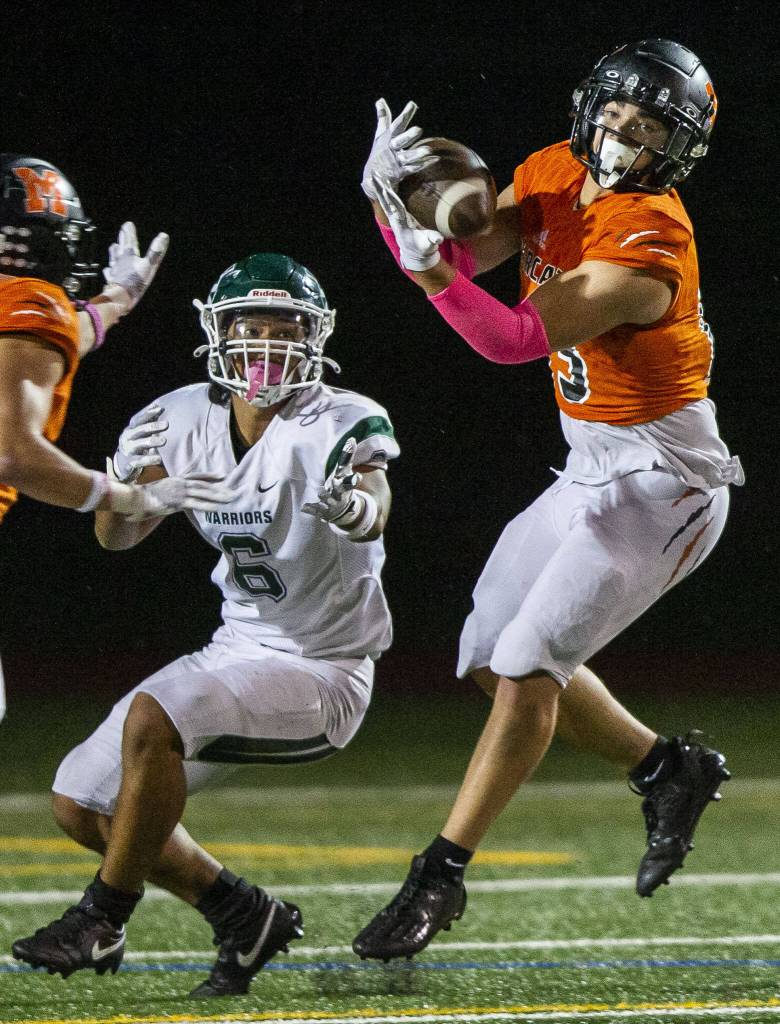 Monroes Aaron Clifton intercepts a pass to Edmonds-Woodways Jesse Hart during the game on Friday, Oct. 13, 2023 in Monroe, Washington. (Olivia Vanni / The Herald)