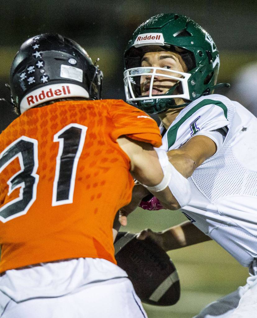 Edmonds-Woodways Steven Warren grimaces while he braces for a tackle during the game against Monroe on Friday, Oct. 13, 2023 in Monroe, Washington. (Olivia Vanni / The Herald)