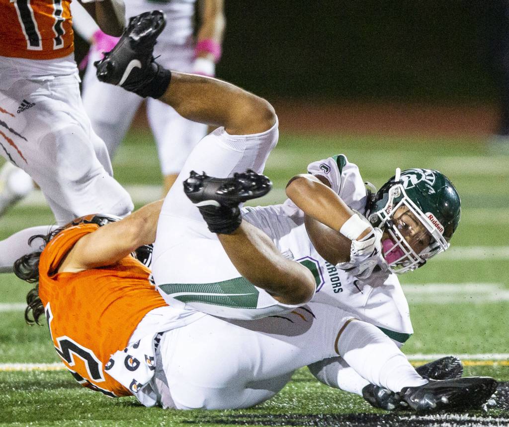 Edmonds-Woodways Jesse Hart is tackled during the game against Monroe on Friday, Oct. 13, 2023 in Monroe, Washington. (Olivia Vanni / The Herald)
