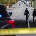 Everett police officers survey the scene of a shooting along East Casino Road on Friday, Oct. 13, 2023 in Everett, Washington. (Olivia Vanni / The Herald)