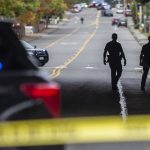 Everett police officers survey the scene of a shooting along East Casino Road on Friday, Oct. 13, 2023 in Everett, Washington. (Olivia Vanni / The Herald)