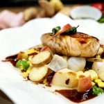 Honey miso-glazed black cod with spicy bacon-apple and padron pepper succotash. (Tulalip Resort Casino)