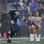 Seattle Seahawks offensive tackle Abraham Lucas (72) runs out on to the field before an NFL pre-season football game against the Minnesota Vikings, Thursday, Aug. 10, 2023 in Seattle. (AP Photo/Ben VanHouten)