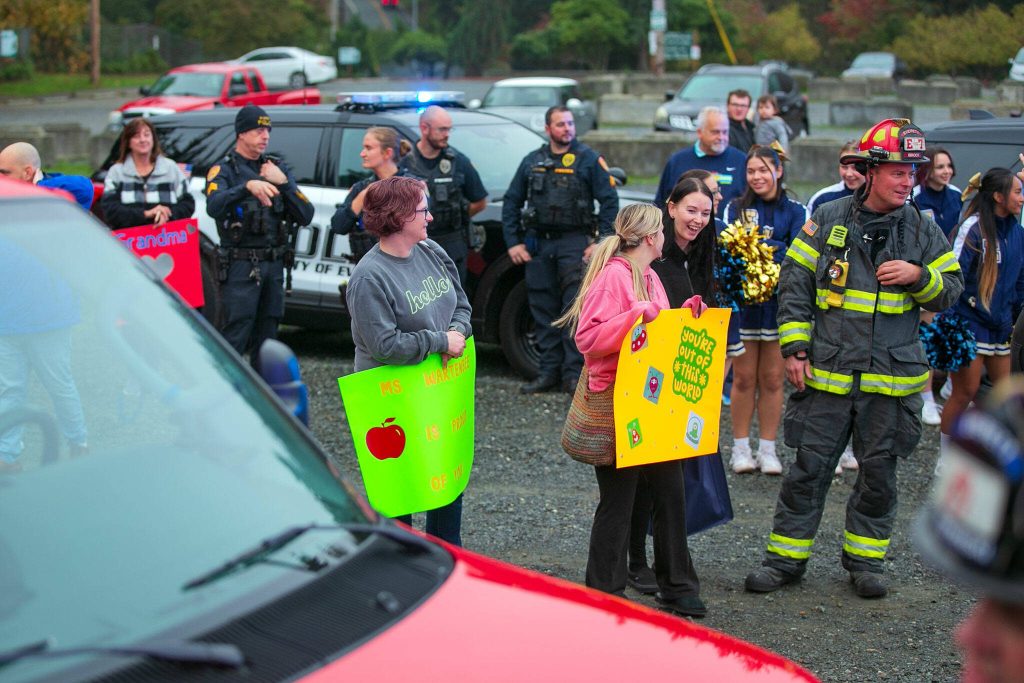 Carsons family, friends and dozens of supporters hang out and watch as he gets a tour of a number of vehicles during a surprise Make-A-Wish sendoff Saturday, Oct. 21, 2023, at Thornton A. Sullivan Park in Everett, Washington. (Ryan Berry / The Herald)