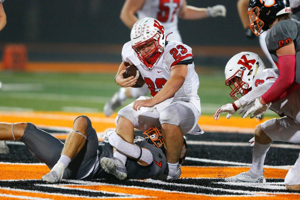 Kings running back Quinn Carlson is taken down by Granite Falls on Friday, Oct. 20, 2023, at Granite Falls High School in Granite Falls, Washington. (Ryan Berry / The Herald)