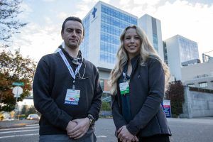 Aaron Warnock, left, and Angela Korneev, right, both registered nurses at Providence stand outside of Providence Regional Medical Center Everett on Thursday, Oct. 26, 2023. (Olivia Vanni / The Herald)