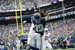 Seattle Seahawks wide receiver Jake Bobo (19) makes a touchdown catch against Arizona Cardinals cornerback Starling Thomas V, left, as Cardinals cornerback Garrett Williams (21) loooks on during the first half of an NFL football game Sunday, Oct. 22, 2023, in Seattle. (AP Photo/Lindsey Wasson)