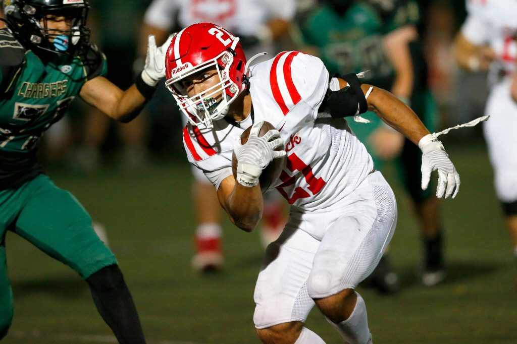 Marysville Pilchucks Kenai Sinaphet runs the ball against Marysville Getchell during the Berry Bowl Sept. 15 at Quil Ceda Stadium in Marysville. (Ryan Berry / The Herald)