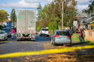 Neighbors take a look at the damage after a semi took down power lines and a few poles on East Grand Avenue on Wednesday, Oct. 25, 2023, in Everett, Washington. (Ryan Berry / The Herald)