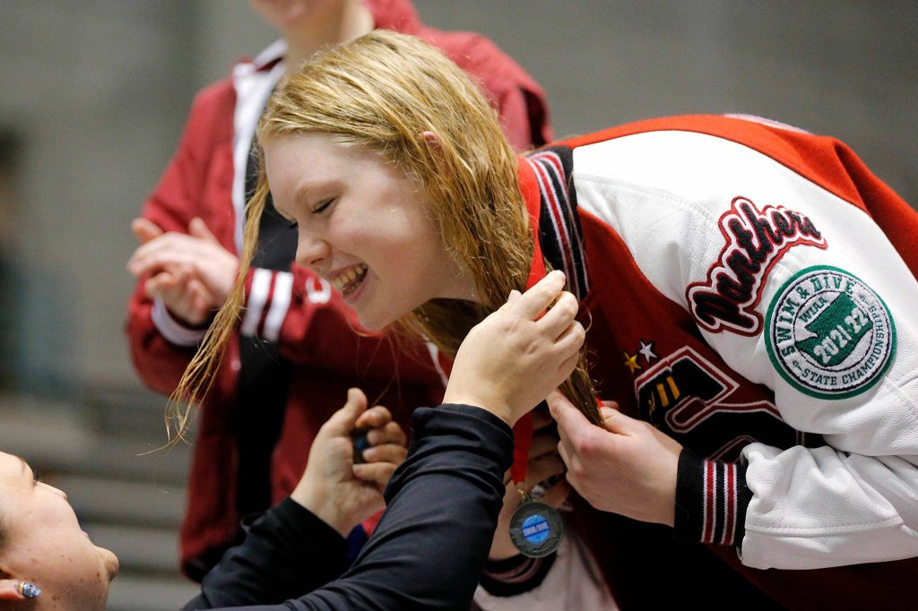 Mary Clarke of Snohomish High School is awarded a medal for taking second in state in the 100-yard freestyle during the Class 3A swim and dive championships on Nov. 12, 2022, at the King County Aquatic Center in Federal Way. (Ryan Berry / The Herald)