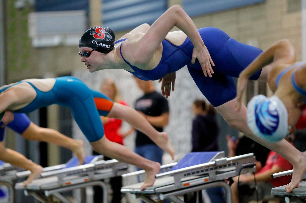 Snohomishs Mary Clarke dives in to begin the 100-yard freestyle during the Class 3A District swim meet Saturday, Nov. 5, 2022, at Snohomish Aquatic Center in Snohomish, Washington. (Ryan Berry / The Herald)