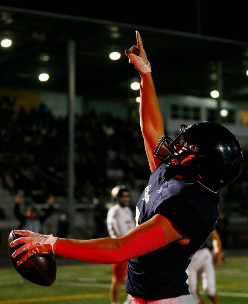 Arlingtons Caleb Reed celebrates a first quarter touchdown against Monroe on Friday, Oct. 27, 2023, at Arlington High School in Arlington, Washington. (Ryan Berry / The Herald)